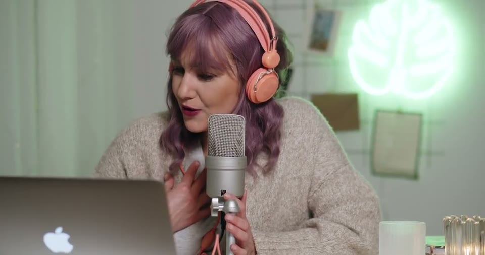 Host recording a podcast episode into a studio microphone, source material for short-form clips
